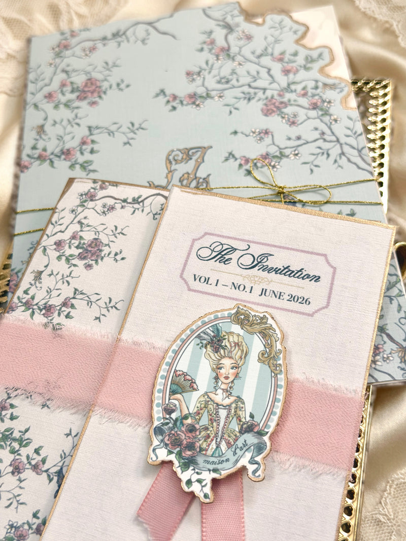 Decorative invitation booklet and floral château stationery wrapped with blush ribbon as part of the From the Chateau Mail Club