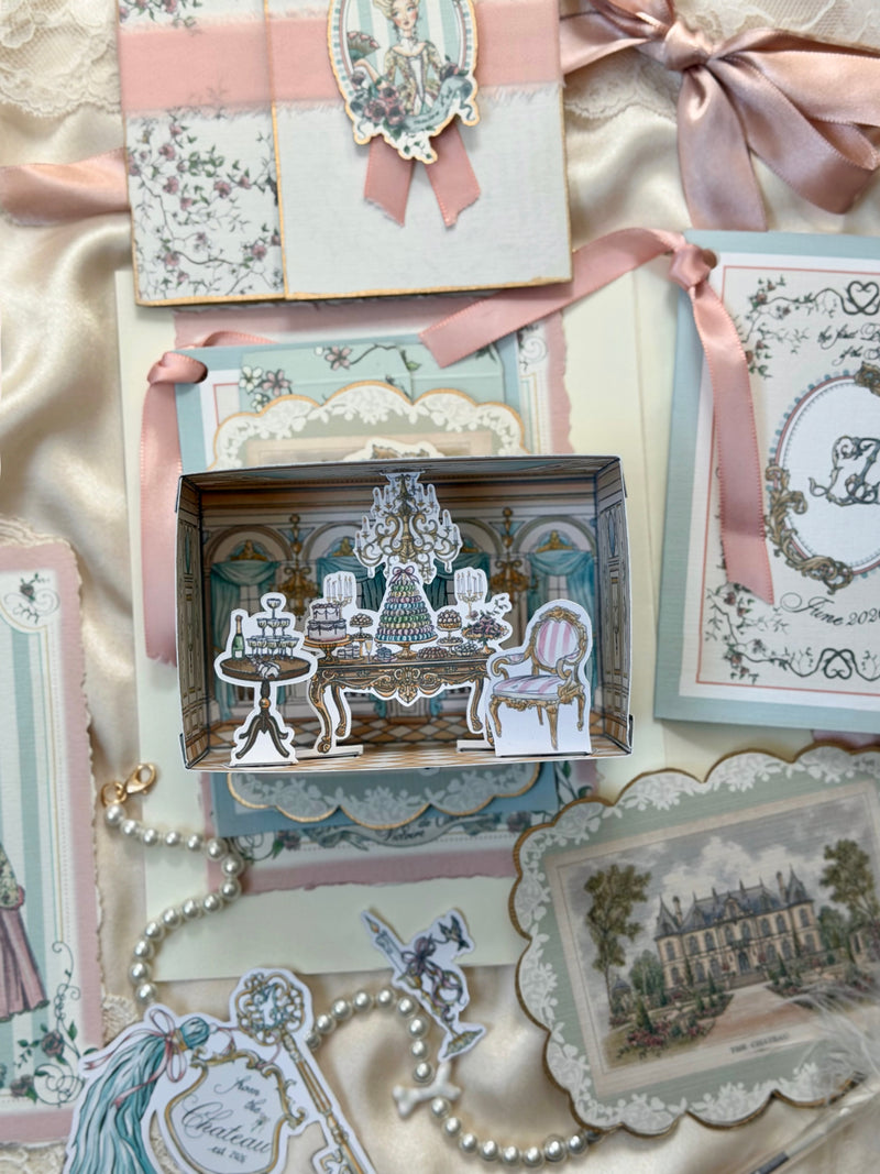 Château-inspired miniature room craft featuring an elegant ballroom scene with chandelier, desserts, and vintage furnishings